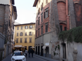 Charming residential street in Oltrarno neighborhood with local shops