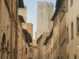 Medieval stone towers and narrow street in San Gimignano