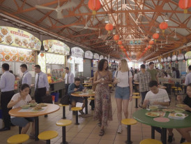 Busy lunch crowd with office workers queuing at multiple stalls