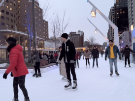 Outdoor winter skating rink with skaters 