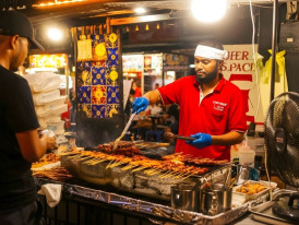 Lau Pa Sat ironwork with satay smoke on Boon Tat Street at night