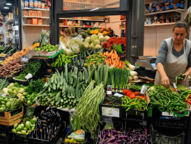 Inside Mercato Centrale with vendors arranging fresh vegetables and meats