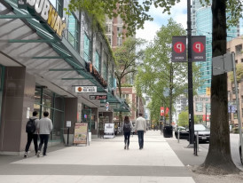 Street with a mix of chain and small restaurants on Robson Street