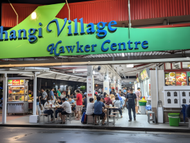 Dawn light over Changi Village shophouses with empty market stalls