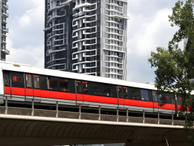 Modern MRT train at station platform with directional signage