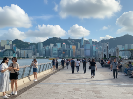 View of Hong Kong's skyline and tourists walking around