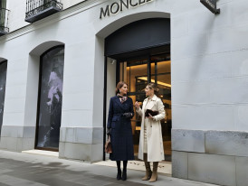 Luxury storefronts along tree-lined Calle Serrano shopping street