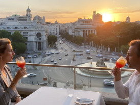 Madrid rooftops at sunset with Cibeles Fountain lit in distance