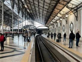 Train platform at Rossio Station with travelers waiting for the Sintra line