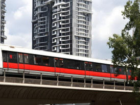 Modern MRT train at station platform with directional signage