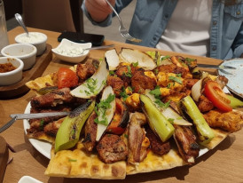 Ocakbasi grill platter with salads and flatbreads