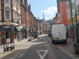 Brick Lane street sign with a mosque minaret