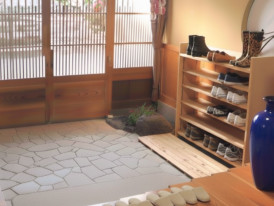 Japanese genkan entryway with wooden shoe shelves and sliding doors