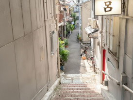 Narrow stone stairway alley in Karahori with metal handrails
