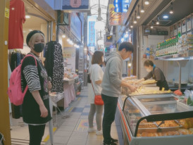 Shoppers buying kimchi and prepared foods at Ikuno Market in Osaka