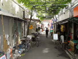 Quiet back street in Asakusa near Sensō-ji, with closed shops and bicycles in the early morning