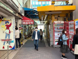 Side street in Akihabara, Tokyo with vending machines and small shops