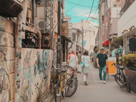 People walking past vintage shops on a narrow street in Shimokitazawa, Tokyo