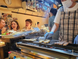 Yakitori grilling over charcoal inside Omoide Yokocho, Tokyo’s famous street food alley