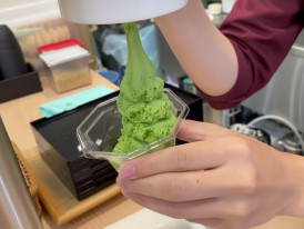 Matcha soft serve ice cream being dispensed at a Tokyo street food stall