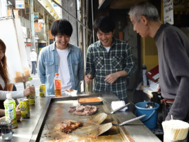 Customers eating at a horumon grill in Nishinari, Osaka