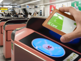 Tapping a Suica IC card on an automatic ticket gate at a Tokyo train station