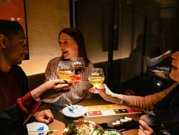 Travelers enjoying food with a local host in Kyoto, Jap Travelers enjoying food with a local host in Kyoto, Jap