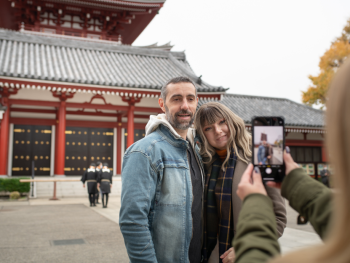 Couple standing in front of the Senso-ji Temple, Japan Couple standing in front of the Senso-ji Temple, Japan