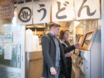 Tourists booking their bus home after a tour in Tokyo,