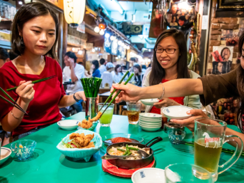 Travelers enjoying traditional Japanese food Travelers enjoying traditional Japanese food