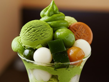 Elaborate matcha parfait with layers of green tea ice cream, jelly, and traditional Japanese sweets Elaborate matcha parfait with layers of green tea ice cream, jelly, and traditional Japanese sweets