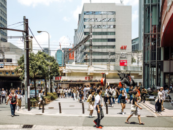Crowded street scene in central Osaka with tourists and locals navigating busy sidewalks. Crowded street scene in central Osaka with tourists and locals navigating busy sidewalks.