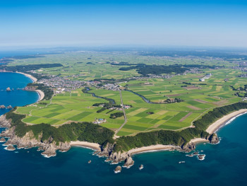 Panoramic view of Awaji Island's coastline and agricultural fields from an elevated viewpoint. Panoramic view of Awaji Island's coastline and agricultural fields from an elevated viewpoint.