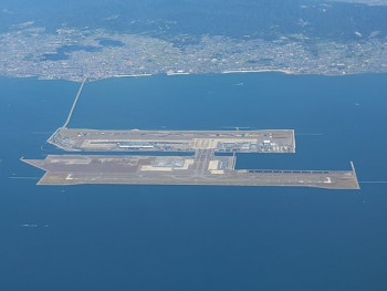 Aerial view of Kansai International Airport on its artificial island surrounded by Osaka Bay waters. Aerial view of Kansai International Airport on its artificial island surrounded by Osaka Bay waters.