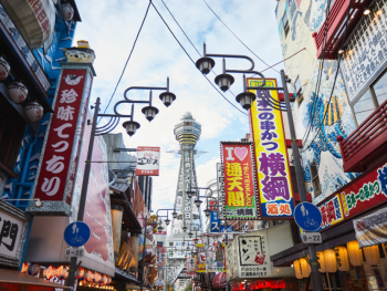 Traditional street scene in Shinsekai district with vintage signs and local restaurants Traditional street scene in Shinsekai district with vintage signs and local restaurants
