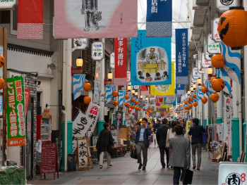 Long covered shopping arcade with traditional storefronts and lanterns Long covered shopping arcade with traditional storefronts and lanterns