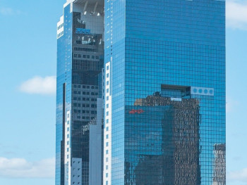 Umeda Sky Building's unique architecture against a blue sky. Image by Umeda Sky Building's unique architecture against a blue sky. Image by