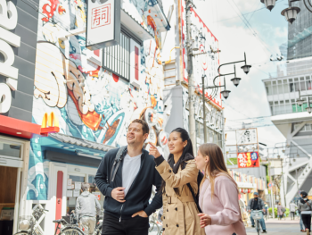 Visitors taking photos of Osaka scenery during golden hour. Visitors taking photos of Osaka scenery during golden hour.