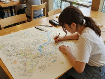 Overhead of a personalized map sketch session in a café Overhead of a personalized map sketch session in a café