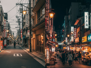 Contrast of quiet daytime street vs bustling night scene Contrast of quiet daytime street vs bustling night scene