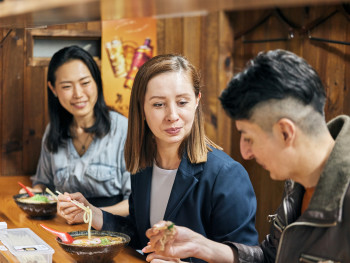 A family sampling food together at night A family sampling food together at night