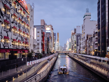 Dotonbori at night, with neon signs reflected in the canal Dotonbori at night, with neon signs reflected in the canal