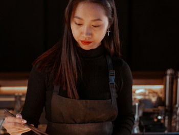 Guest learning proper chopstick technique from host at a traditional restaurant. Photo by Mikhail Nilov on pexels Guest learning proper chopstick technique from host at a traditional restaurant. Photo by Mikhail Nilov on pexels