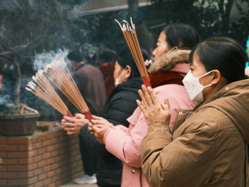 Locals making traditional winter prayers for good fortune at a small shrine, with steam from their breath visible in the cold air Photo by Đào Việt Hoàng on Unsplash Locals making traditional winter prayers for good fortune at a small shrine, with steam from their breath visible in the cold air Photo by Đào Việt Hoàng on Unsplash