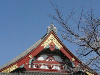 Traditional temple roof against blue sky. Photo by Cherry T on Unsplash