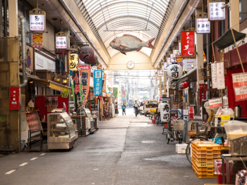 Kuromon Market interior showing narrow aisles packed with local shoppers and vendors. Kuromon Market interior showing narrow aisles packed with local shoppers and vendors.