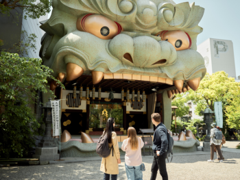 Namba Yasaka Shrine's distinctive lion head stage with traditional architecture against backdrop of modern buildings. Namba Yasaka Shrine's distinctive lion head stage with traditional architecture against backdrop of modern buildings.