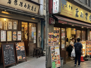 A local eatery with handwritten menus contrasted with a tourist-focused restaurant with bright signage and photo menus. A local eatery with handwritten menus contrasted with a tourist-focused restaurant with bright signage and photo menus.