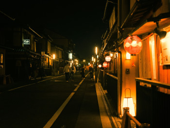 Quiet side street in Gion at dusk with traditional wooden buildings and softly glowing lanterns. Image by Ayumi Kubo on Unsplash. Quiet side street in Gion at dusk with traditional wooden buildings and softly glowing lanterns. Image by Ayumi Kubo on Unsplash.