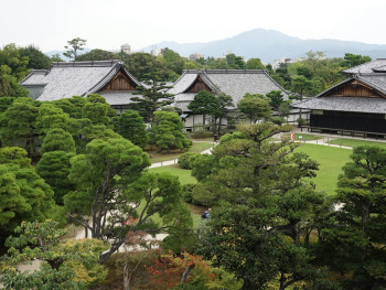 Imperial Palace gardens with traditional landscaping and distant mountains Photo by YQ Tian on Unsplash